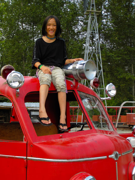 Claire sitting on the fire truck cab at Remlinger Farms.